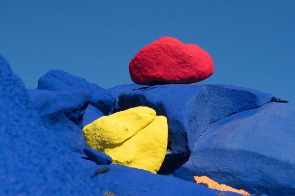 yellow and red stone on blue rocks